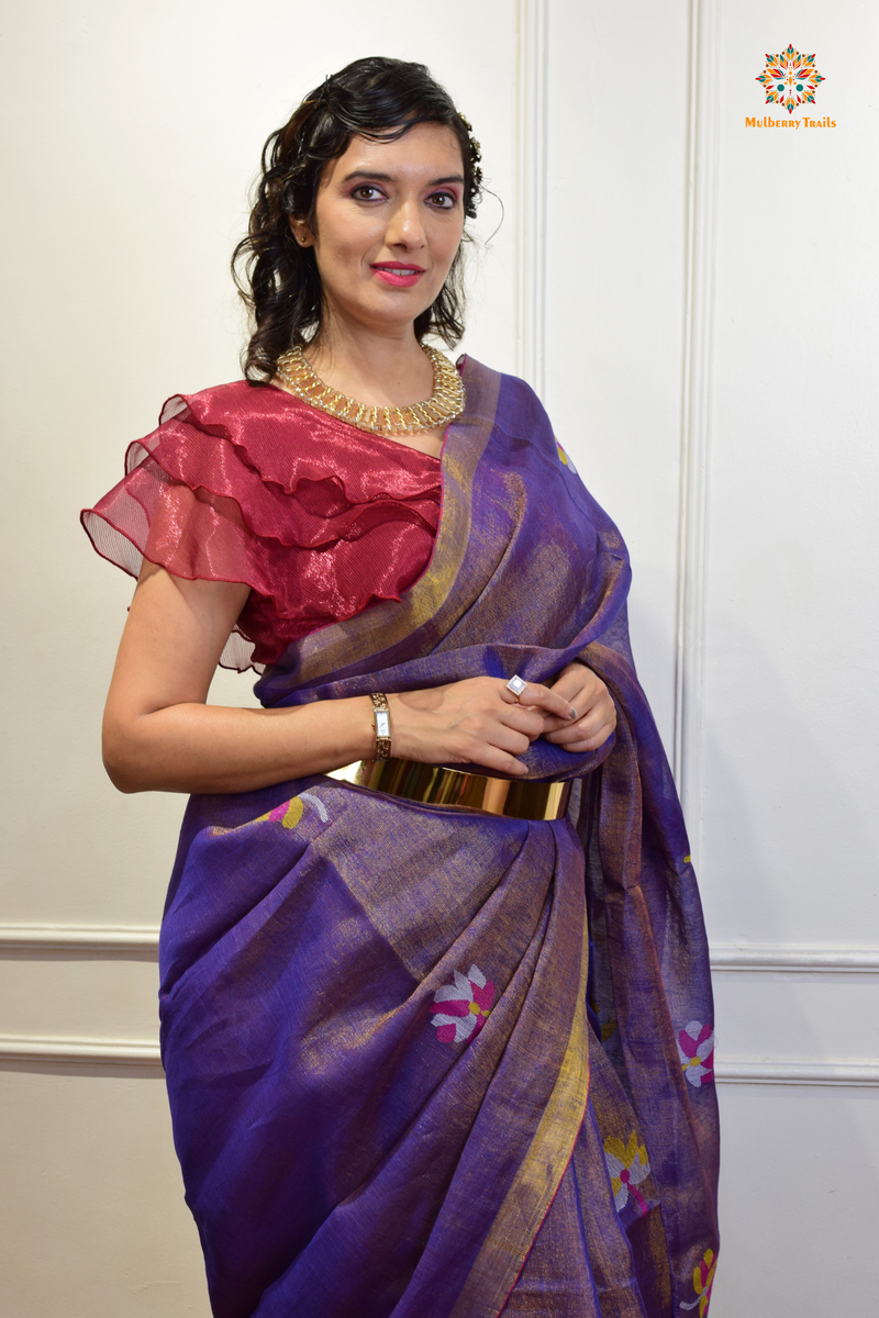 This image features an Elegant tissue saree featuring intricate handwoven Jamdani lotus motifs, with a lightweight, shimmery fabric that drapes beautifully, perfect for festive and special occasions. Party wear , diwali theme. 