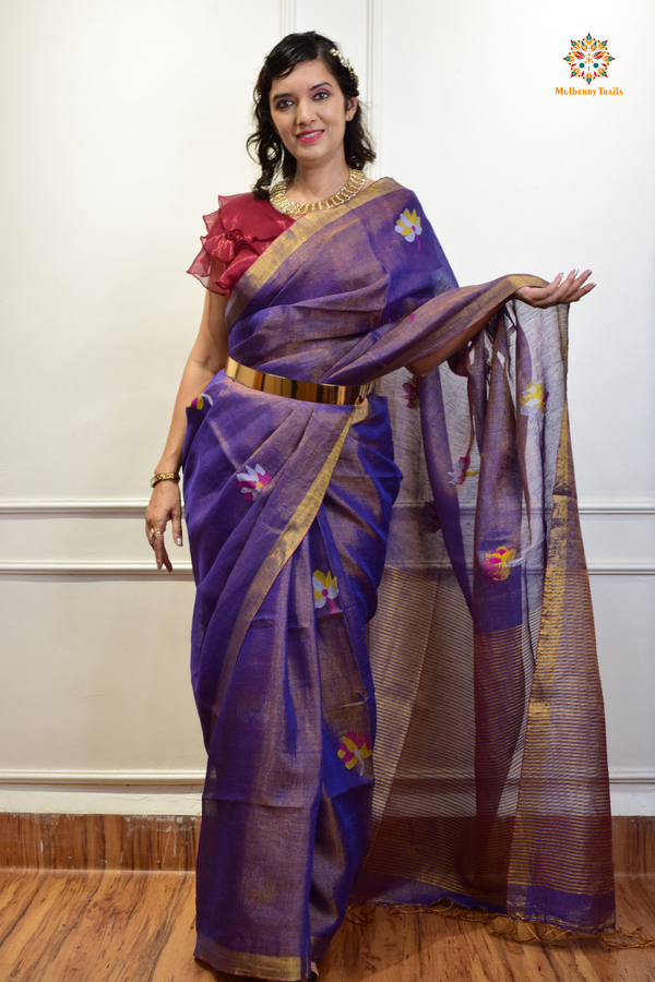 This image features an Elegant tissue saree featuring intricate handwoven Jamdani lotus motifs, with a lightweight, shimmery fabric that drapes beautifully, perfect for festive and special occasions. Party wear , diwali theme. 