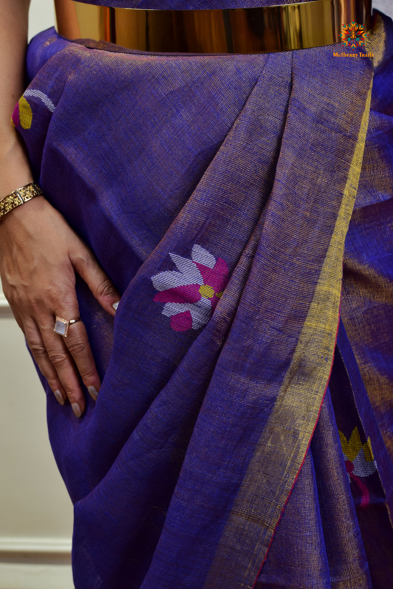 This image features an Elegant tissue saree featuring intricate handwoven Jamdani lotus motifs, with a lightweight, shimmery fabric that drapes beautifully, perfect for festive and special occasions. Party wear , diwali theme. 