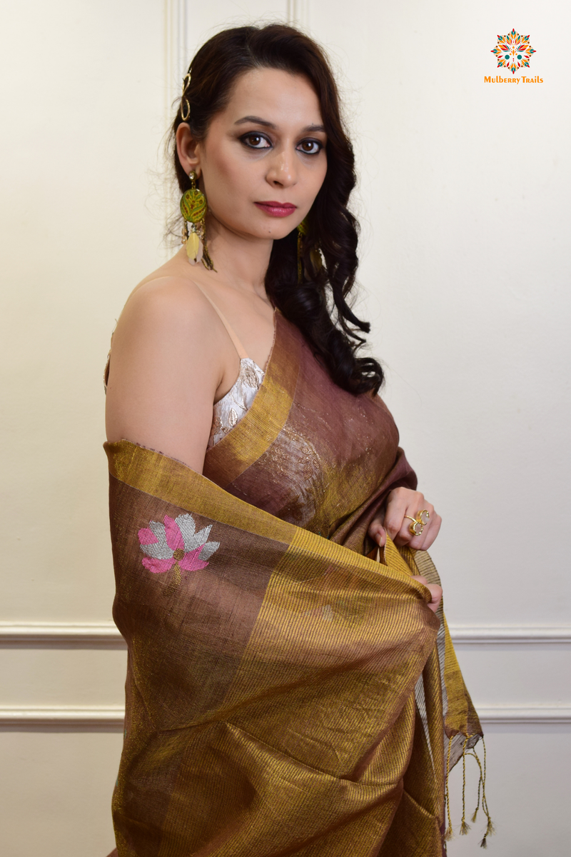 This image features an Elegant tissue saree featuring intricate handwoven Jamdani lotus motifs, with a lightweight, shimmery fabric that drapes beautifully, perfect for festive and special occasions. Party wear , diwali theme. 