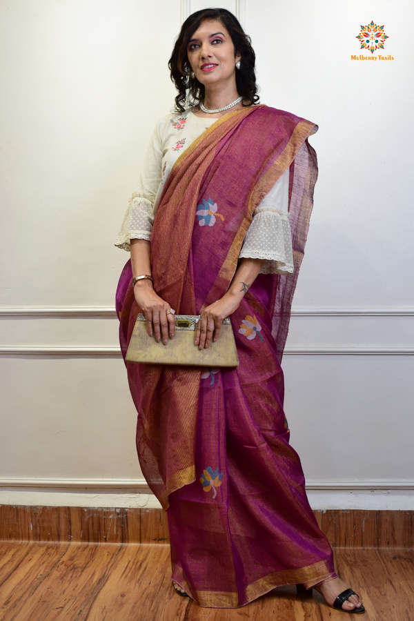 This image features an Elegant tissue saree featuring intricate handwoven Jamdani lotus motifs, with a lightweight, shimmery fabric that drapes beautifully, perfect for festive and special occasions. Party wear , diwali theme. 