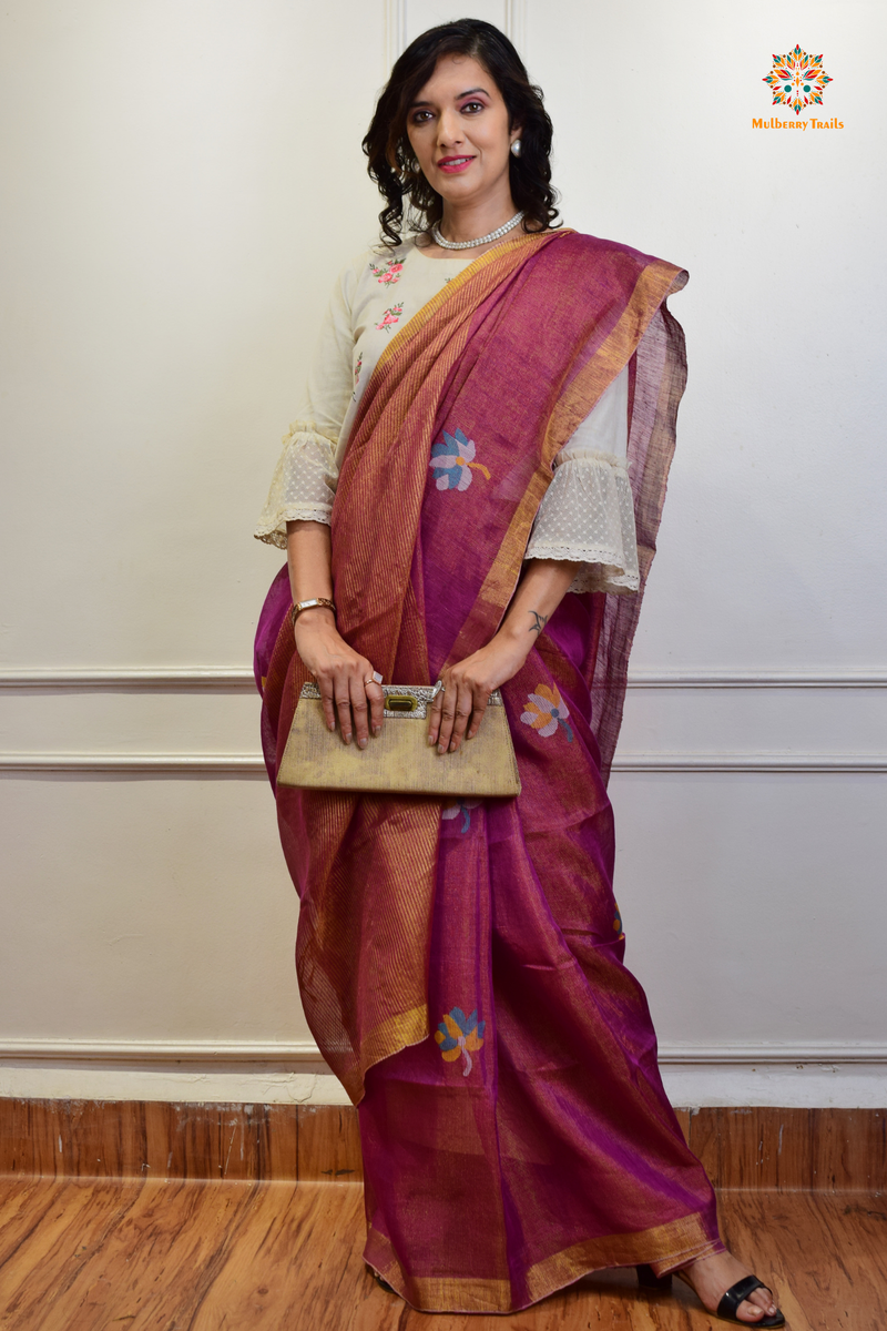 This image features an Elegant tissue saree featuring intricate handwoven Jamdani lotus motifs, with a lightweight, shimmery fabric that drapes beautifully, perfect for festive and special occasions. Party wear , diwali theme. 