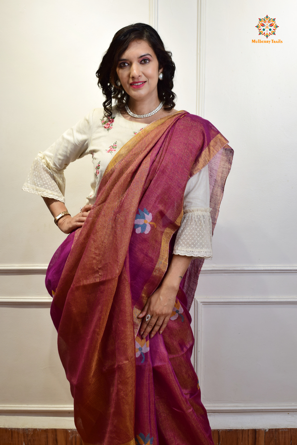 This image features an Elegant tissue saree featuring intricate handwoven Jamdani lotus motifs, with a lightweight, shimmery fabric that drapes beautifully, perfect for festive and special occasions. Party wear , diwali theme. 