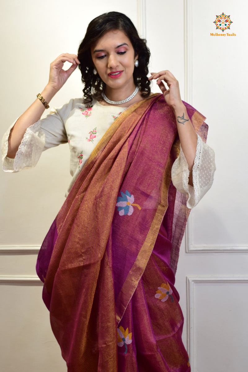 This image features an Elegant tissue saree featuring intricate handwoven Jamdani lotus motifs, with a lightweight, shimmery fabric that drapes beautifully, perfect for festive and special occasions. Party wear , diwali theme. 