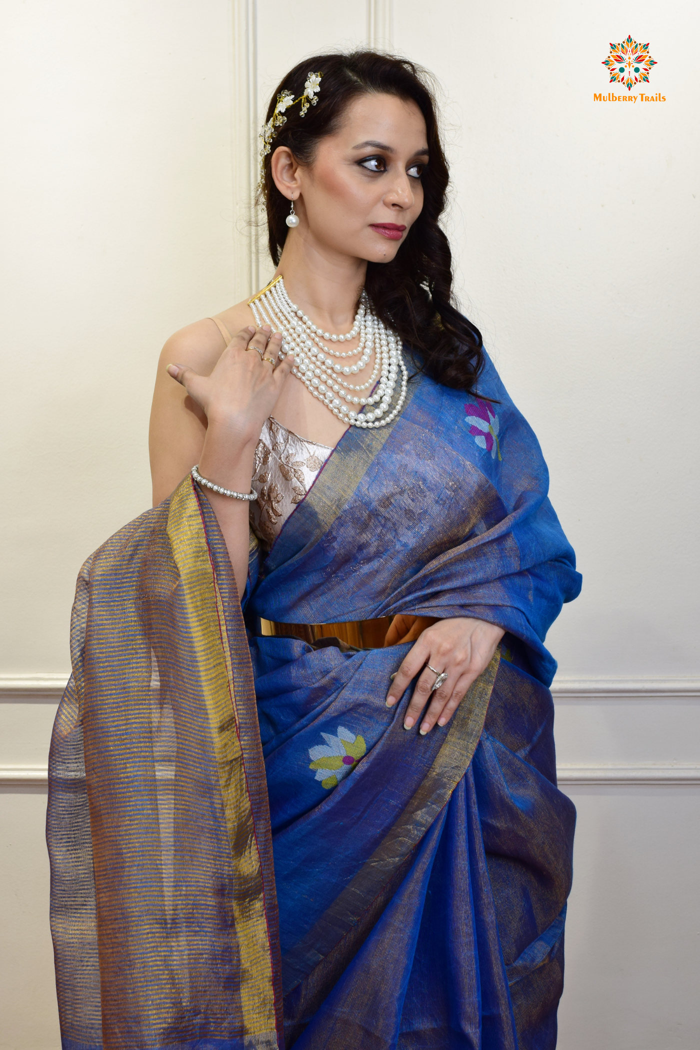 This image features an Elegant tissue saree featuring intricate handwoven Jamdani lotus motifs, with a lightweight, shimmery fabric that drapes beautifully, perfect for festive and special occasions. Party wear , diwali theme. 