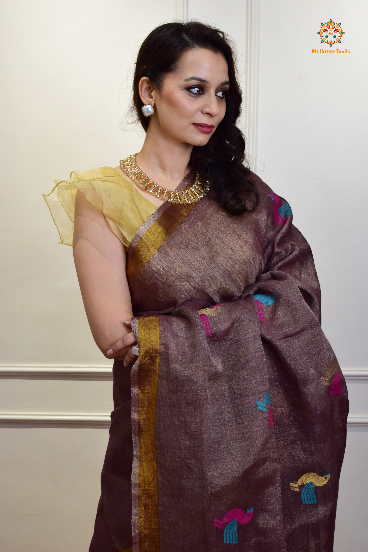 This image features an Elegant tissue saree featuring intricate handwoven Jamdani lotus motifs, with a lightweight, shimmery fabric that drapes beautifully, perfect for festive and special occasions. Party wear , diwali theme. 