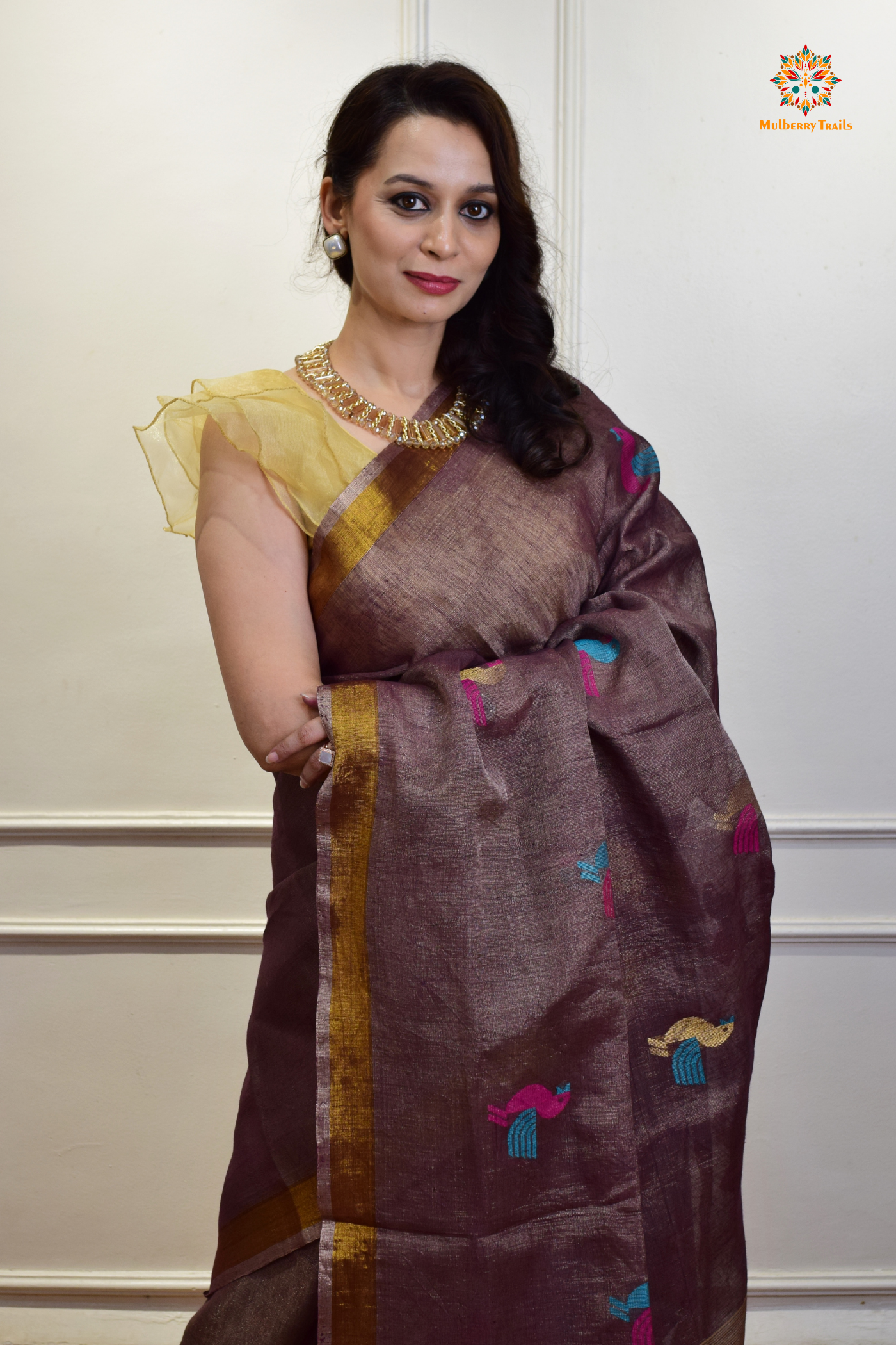 This image features an Elegant tissue saree featuring intricate handwoven Jamdani lotus motifs, with a lightweight, shimmery fabric that drapes beautifully, perfect for festive and special occasions. Party wear , diwali theme. 