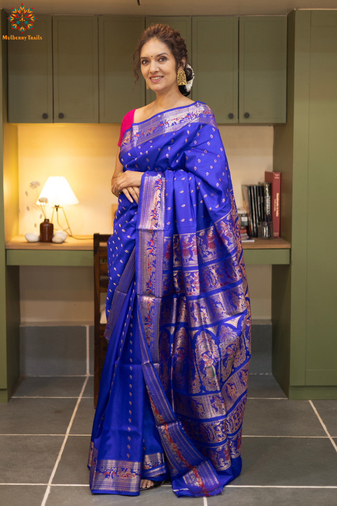 Swarnachari – Pure Silk Hazarbutta Saree

1. “Pure silk Swarnachari saree with hazarbutta thousand-motif weave and copper zari detailing for a regal look.”

2. “Silk Mark pure silk hazarbutta saree featuring intricate copper zari motifs and rich texture.” 
Woman wearing a black and copper zari saree in a room with a desk and lamp.