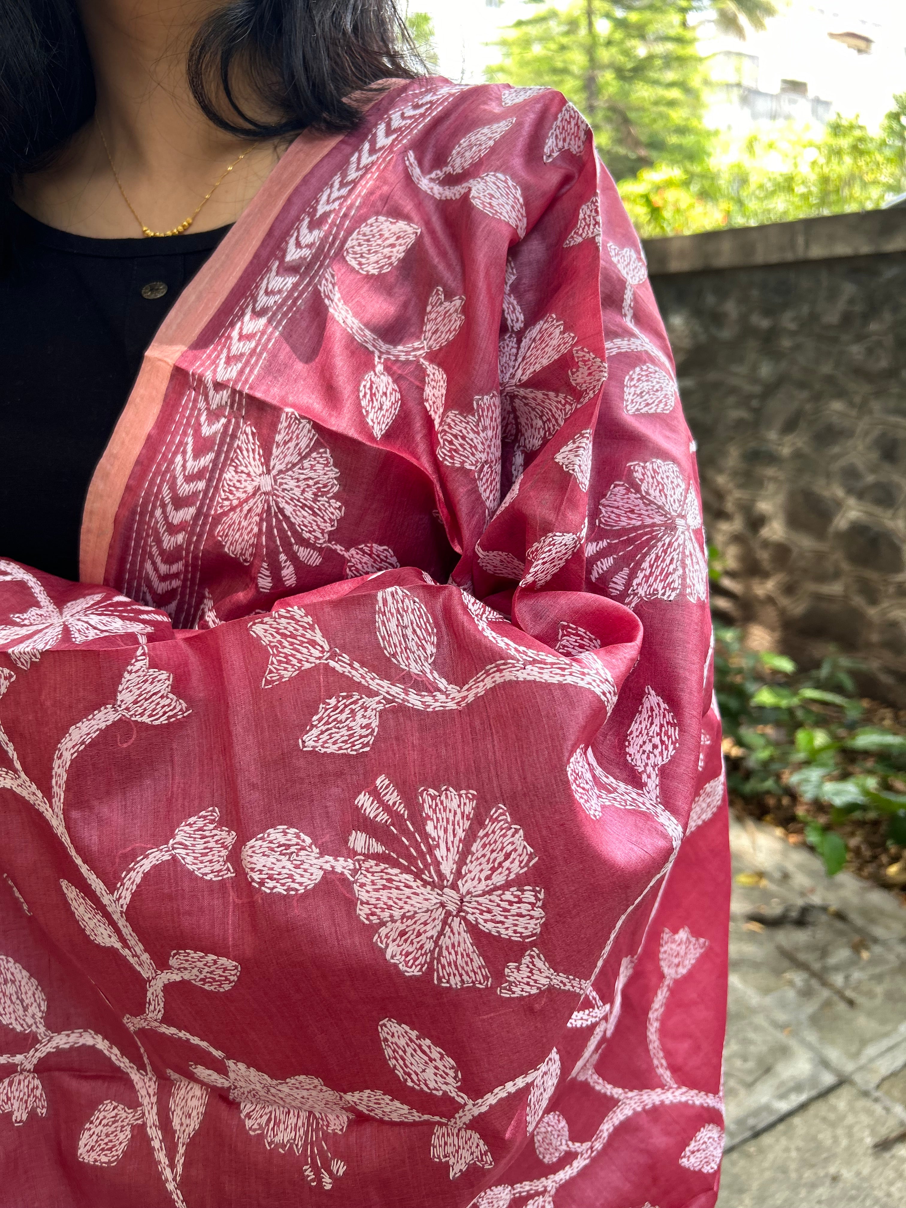 Elegant pure silk dupatta in peach Orange color, featuring intricate Kantha embroidery with vibrant floral and paisley motifs. The dupatta boasts a luxurious sheen and a rich texture, perfect for adding a touch of sophistication to any outfit. The hand-embroidered details highlight the traditional craftsmanship and artistry, making it a statement accessory for festive occasions or special events.