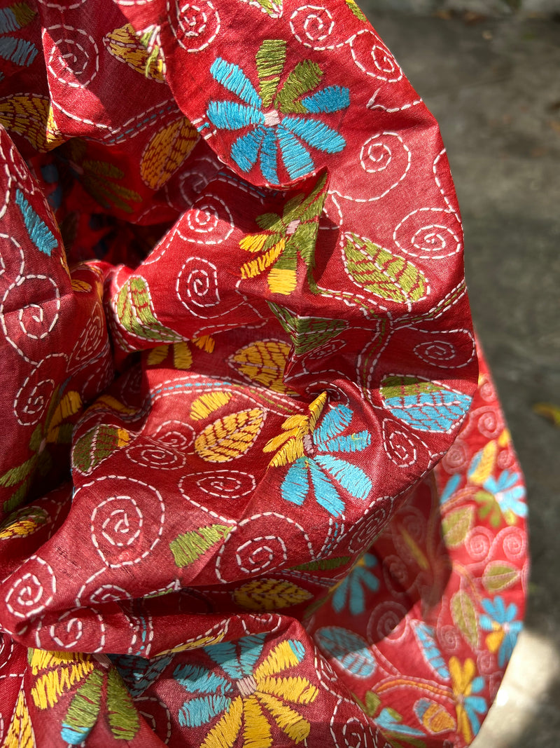 Elegant pure silk dupatta in peach Orange color, featuring intricate Kantha embroidery with vibrant floral and paisley motifs. The dupatta boasts a luxurious sheen and a rich texture, perfect for adding a touch of sophistication to any outfit. The hand-embroidered details highlight the traditional craftsmanship and artistry, making it a statement accessory for festive occasions or special events.