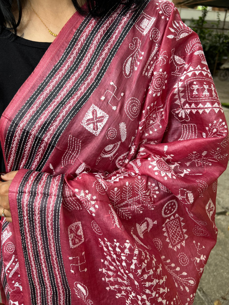 Elegant pure silk dupatta in Mauve color, featuring intricate Warli Kantha embroidery with vibrant floral and paisley motifs. The dupatta boasts a luxurious sheen and a rich texture, perfect for adding a touch of sophistication to any outfit. The hand-embroidered details highlight the traditional craftsmanship and artistry, making it a statement accessory for festive occasions or special events.