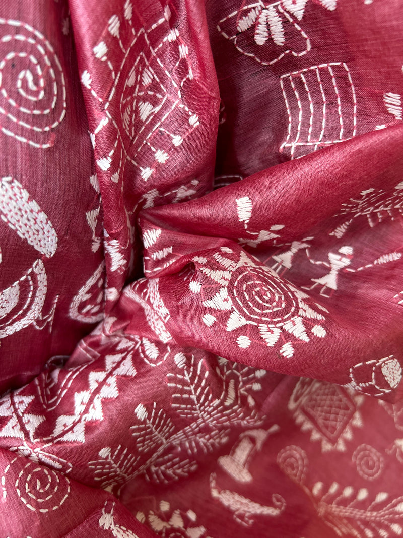 Elegant pure silk dupatta in Mauve color, featuring intricate Warli Kantha embroidery with vibrant floral and paisley motifs. The dupatta boasts a luxurious sheen and a rich texture, perfect for adding a touch of sophistication to any outfit. The hand-embroidered details highlight the traditional craftsmanship and artistry, making it a statement accessory for festive occasions or special events.